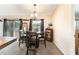 The dining area features a round wooden table with chairs and dark curtains at 159 Water Trak, Ocala, FL 34472