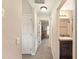 Hallway view leading to an additional room and an attached bathroom with granite vanity at 159 Water Trak, Ocala, FL 34472