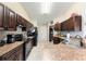 Well-lit kitchen boasts dark wood cabinets and a neutral countertop space at 159 Water Trak, Ocala, FL 34472