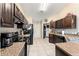 Bright kitchen with dark cabinetry, tile floors, and ample counter space, perfect for cooking at 159 Water Trak, Ocala, FL 34472