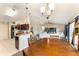 An open-concept living space with a dining area, kitchen, and living room filled with natural light at 159 Water Trak, Ocala, FL 34472