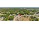 An aerial view showing the home's location within a community with mature trees and nearby roads at 17 Pine Course Loop, Ocala, FL 34472