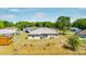 Backyard view of a home with a fenced yard, grassy area, shed, and covered patio space at 17 Pine Course Loop, Ocala, FL 34472