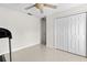Bright bedroom features a ceiling fan, closet and interior doors at 17 Pine Course Loop, Ocala, FL 34472