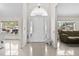 Inviting foyer featuring tile flooring, a decorative glass door, and sunlit windows for a bright entrance at 17 Pine Course Loop, Ocala, FL 34472