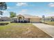 Charming single-story home featuring a two-car garage and well-maintained front lawn at 17 Pine Course Loop, Ocala, FL 34472