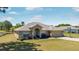 Charming single-story home featuring a two-car garage and well-maintained front lawn at 17 Pine Course Loop, Ocala, FL 34472