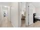 A bright hallway with access to the bedrooms and a bathroom, showcasing the home's layout at 17 Pine Course Loop, Ocala, FL 34472