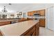 Spacious kitchen with a large island, wood cabinets, modern appliances, and sleek tile flooring at 17 Pine Course Loop, Ocala, FL 34472