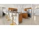 Open kitchen features stainless appliances, breakfast bar with seating, and ceramic tile floors at 17 Pine Course Loop, Ocala, FL 34472