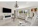 Comfortable living room with large windows, tile flooring, and an electric fireplace at 17 Pine Course Loop, Ocala, FL 34472