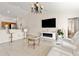 Spacious living room with modern fireplace, tile flooring, and comfortable white seating arrangement at 17 Pine Course Loop, Ocala, FL 34472