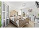 A lovely main bedroom boasts elegant furniture, ample natural light, and a serene ambiance at 17 Pine Course Loop, Ocala, FL 34472