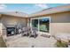 A patio area with a grill, seating, and a sliding glass door leading into the home at 17 Pine Course Loop, Ocala, FL 34472