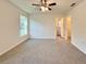 This bedroom offers a simple design with carpet flooring and a ceiling fan at 17710 Sw 48Th Pl, Dunnellon, FL 34432