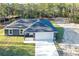 New construction home featuring a modern gray exterior, a black roof, and a spacious two-car garage at 17710 Sw 48Th Pl, Dunnellon, FL 34432