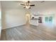 Open-concept living space with light gray wood-look flooring, seamlessly connecting the living and dining areas at 17710 Sw 48Th Pl, Dunnellon, FL 34432