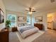 The main bedroom is spacious and bright, with a ceiling fan and a view of the backyard at 17710 Sw 48Th Pl, Dunnellon, FL 34432