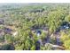 An aerial view of a home surrounded by a forest; a long driveway leads to the house with a dark roof at 17710 Sw 48Th Pl, Dunnellon, FL 34432