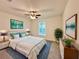 This cozy bedroom features bright white walls and is decorated with plants and matching bedside tables at 17710 Sw 48Th Pl, Dunnellon, FL 34432