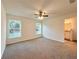 Spacious bedroom featuring two windows providing natural light and ceiling fan at 17710 Sw 48Th Sw Pl, Dunnellon, FL 34432