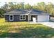 Attractive single-story home featuring a two-car garage, covered front entry and green lawn at 17710 Sw 48Th Pl, Dunnellon, FL 34432