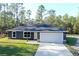 Charming single-story home with a two-car garage, well-manicured lawn, and a beautifully landscaped yard at 17710 Sw 48Th Sw Pl, Dunnellon, FL 34432