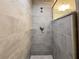 This bathroom features a tile shower with a shower head and modern glass shelving at 17710 Sw 48Th Sw Pl, Dunnellon, FL 34432