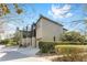 View of the home's side and backyard with a screened porch and tidy landscaping at 1835 Se 22Nd St, Ocala, FL 34471