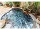 Close-up of the serene water feature with natural rock accents and lush greenery at 1835 Se 22Nd St, Ocala, FL 34471