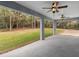 Spacious covered patio has two ceiling fans and a beautiful view of the wooded back yard at 23744 Sw Tiger Lake Blvd, Dunnellon, FL 34432