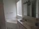 Bathroom with a dual sink vanity, soaking tub, and a neutral tiling at 2459 Nw 55Th Avenue Rd, Ocala, FL 34482