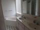 Bathroom with a dual sink vanity, soaking tub, and neutral tiling at 2459 Nw 55Th Avenue Rd, Ocala, FL 34482