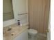 Bathroom features a vanity with a sink and a toilet with a shower at 2459 Nw 55Th Avenue Rd, Ocala, FL 34482