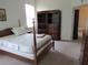 Cozy bedroom with a four-poster bed and a large wardrobe at 2459 Nw 55Th Avenue Rd, Ocala, FL 34482