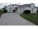 Charming single-story home featuring a well-manicured lawn, mature shrubbery, and a concrete driveway at 2459 Nw 55Th Avenue Rd, Ocala, FL 34482