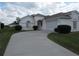 Charming single-story home featuring a well-manicured lawn, mature shrubbery, and a concrete driveway at 2459 Nw 55Th Avenue Rd, Ocala, FL 34482