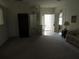 Open living room with neutral carpet and views to entryway, with a couch and storage unit at 2459 Nw 55Th Avenue Rd, Ocala, FL 34482