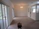 Spacious living room with sliding glass doors leading to a screened-in lanai at 2459 Nw 55Th Avenue Rd, Ocala, FL 34482