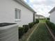 Landscaped side yard featuring a row of neatly trimmed bushes and view of neighboring home at 2459 Nw 55Th Avenue Rd, Ocala, FL 34482