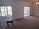 View of the sun room from the living area, featuring a wall of windows and a tile floor at 2459 Nw 55Th Avenue Rd, Ocala, FL 34482