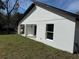Backyard view of the home's exterior featuring stucco wall and green grass at 31 Juniper Pass Ln, Ocala, FL 34480