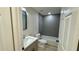 Modern bathroom with tiled shower-tub combo, sleek vanity, and contemporary fixtures at 31 Juniper Pass Ln, Ocala, FL 34480