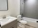 Modern bathroom with gray tile shower, gray vanity and updated sink and faucet at 31 Juniper Pass Ln, Ocala, FL 34480