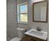 Bathroom featuring a wood-look vanity, quartz counters, and marble-tiled shower at 31 Juniper Pass Ln, Ocala, FL 34480