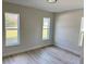 Bright bedroom with two windows and modern flooring, offering a serene space at 31 Juniper Pass Ln, Ocala, FL 34480