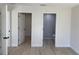 Bedroom with access to the bathroom and closet and featuring neutral walls and wood-look floors at 31 Juniper Pass Ln, Ocala, FL 34480
