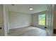 Bright bedroom featuring new hard surface flooring, a window, and neutral paint at 31 Juniper Pass Ln, Ocala, FL 34480