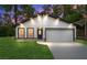 Charming single-story home with modern design elements and well-maintained front lawn at 31 Juniper Pass Ln, Ocala, FL 34480