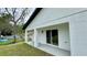 Home's outdoor patio area with support columns, sliding glass door, and exterior lighting at 31 Juniper Pass Ln, Ocala, FL 34480